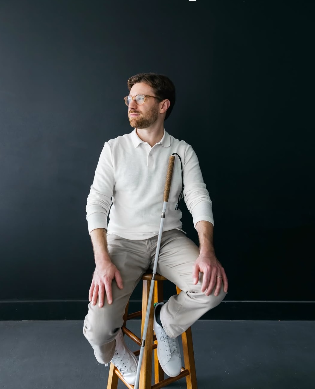 Charlie seated, holding his cane